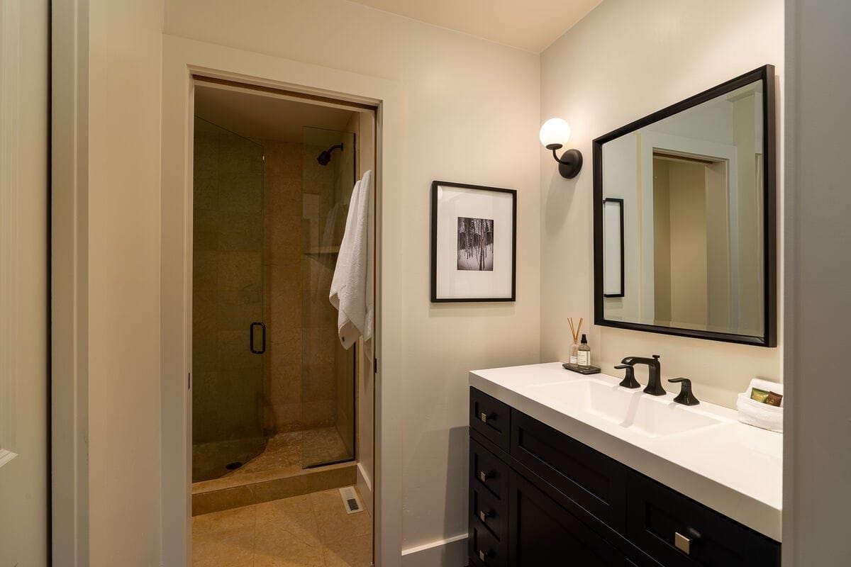 Modern bathroom with shower and vanity.