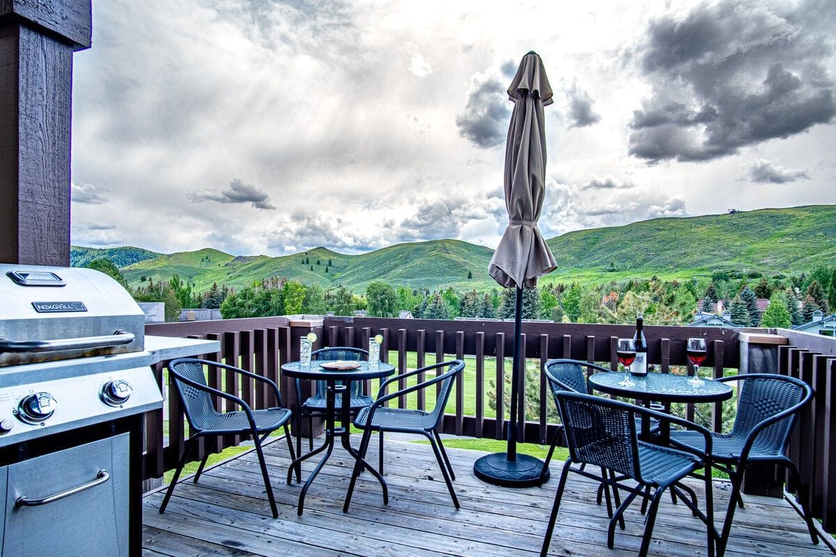 Patio with chairs and mountains.