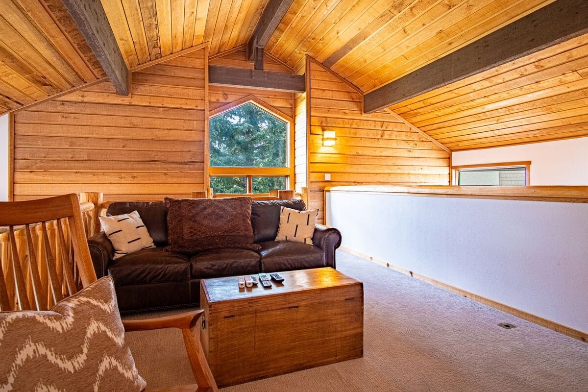 Cozy wooden loft with seating area.