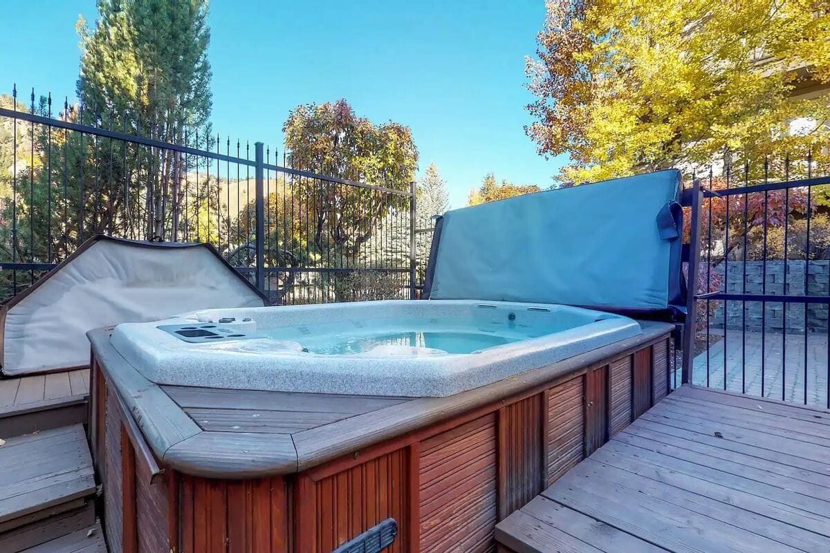 Outdoor hot tub with surrounding trees.