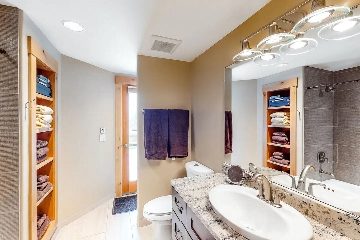 Modern bathroom with towels and sink.