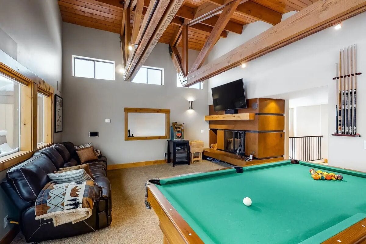 Room with pool table and sofa.