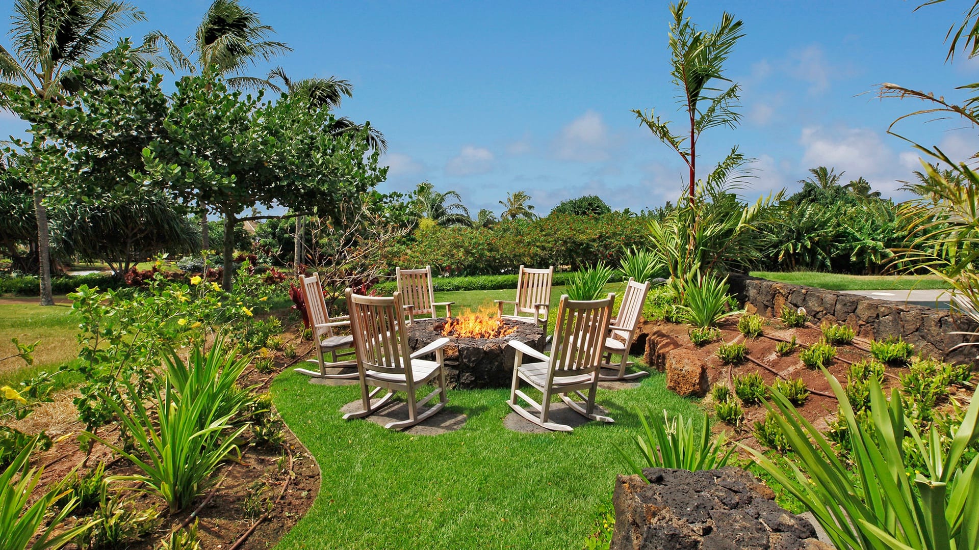 Tropical garden with fire pit.