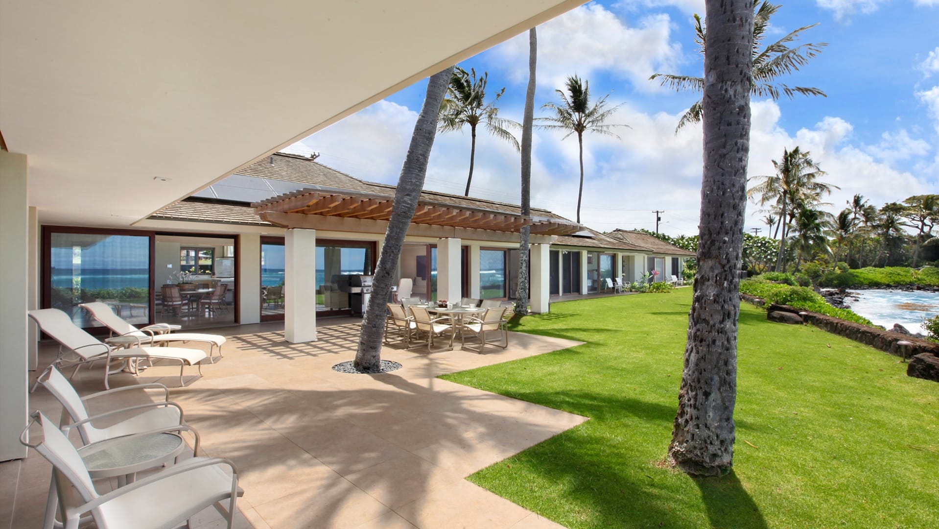 Beachside patio with palm trees.