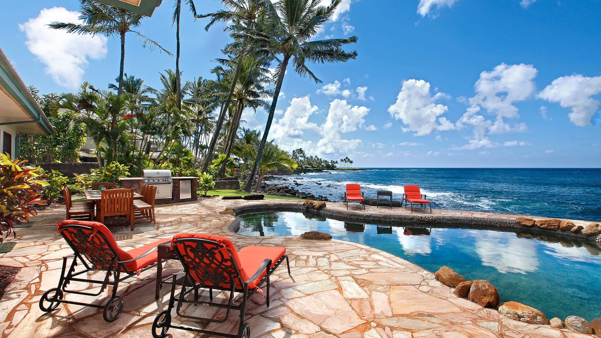 Tropical poolside patio by ocean.