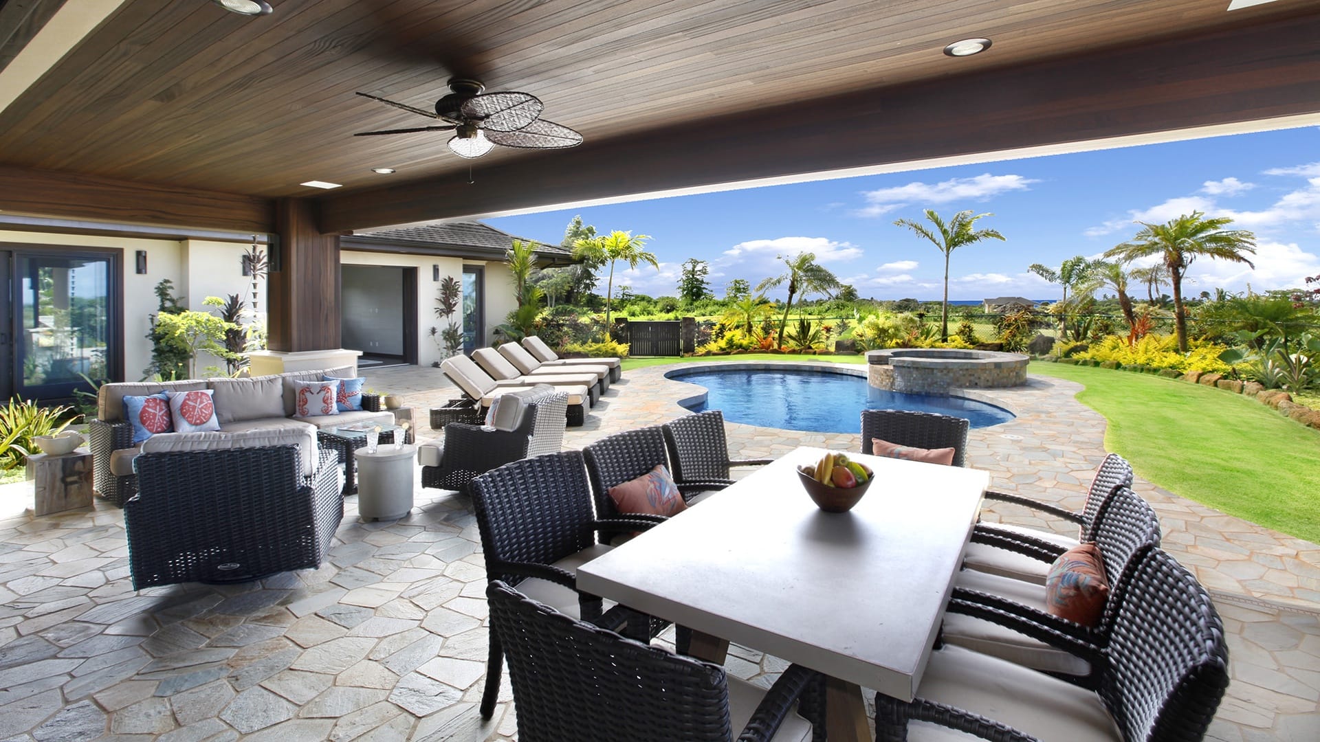 Outdoor patio with pool and seating.