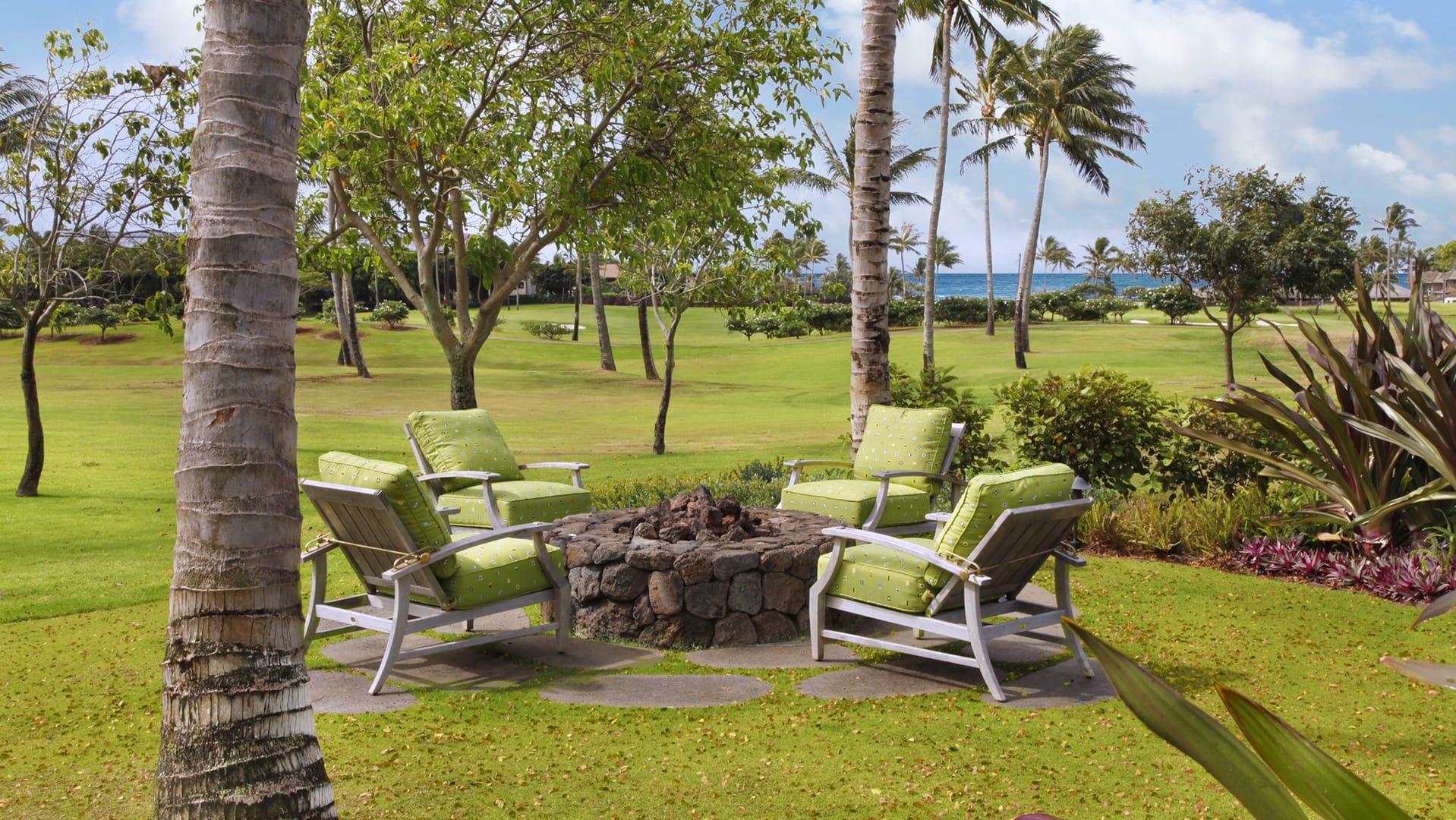 Lounge chairs around outdoor fire pit.