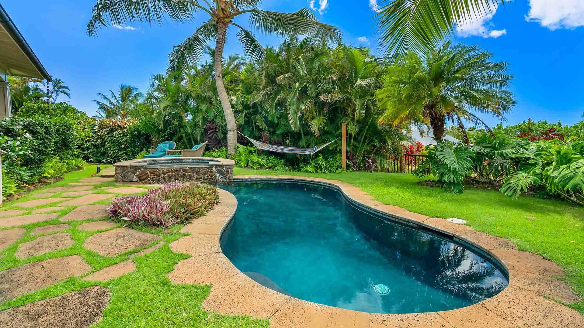 Backyard with pool and hammock.