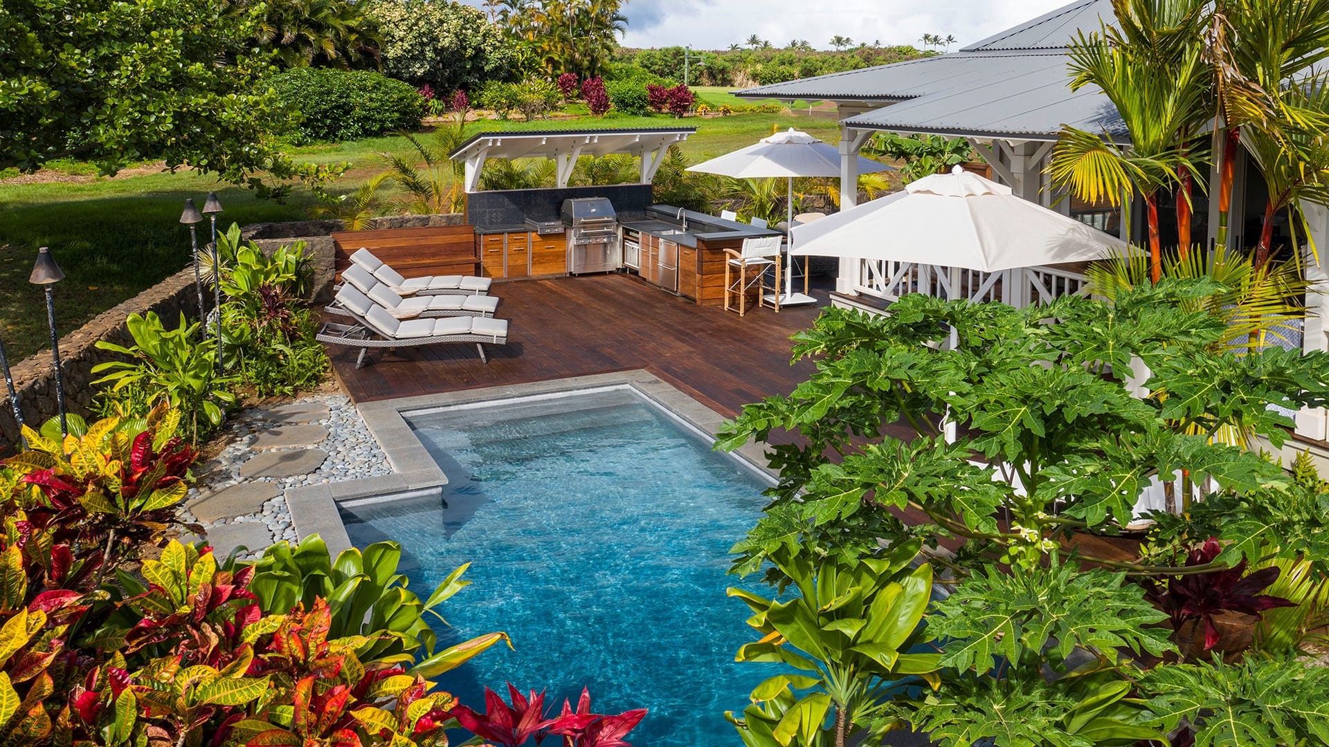 Lush garden with poolside patio.