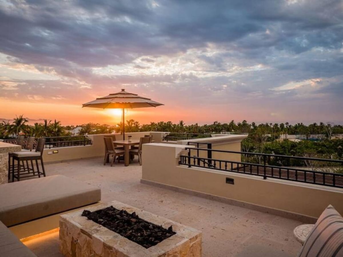 Rooftop patio with sunset view.