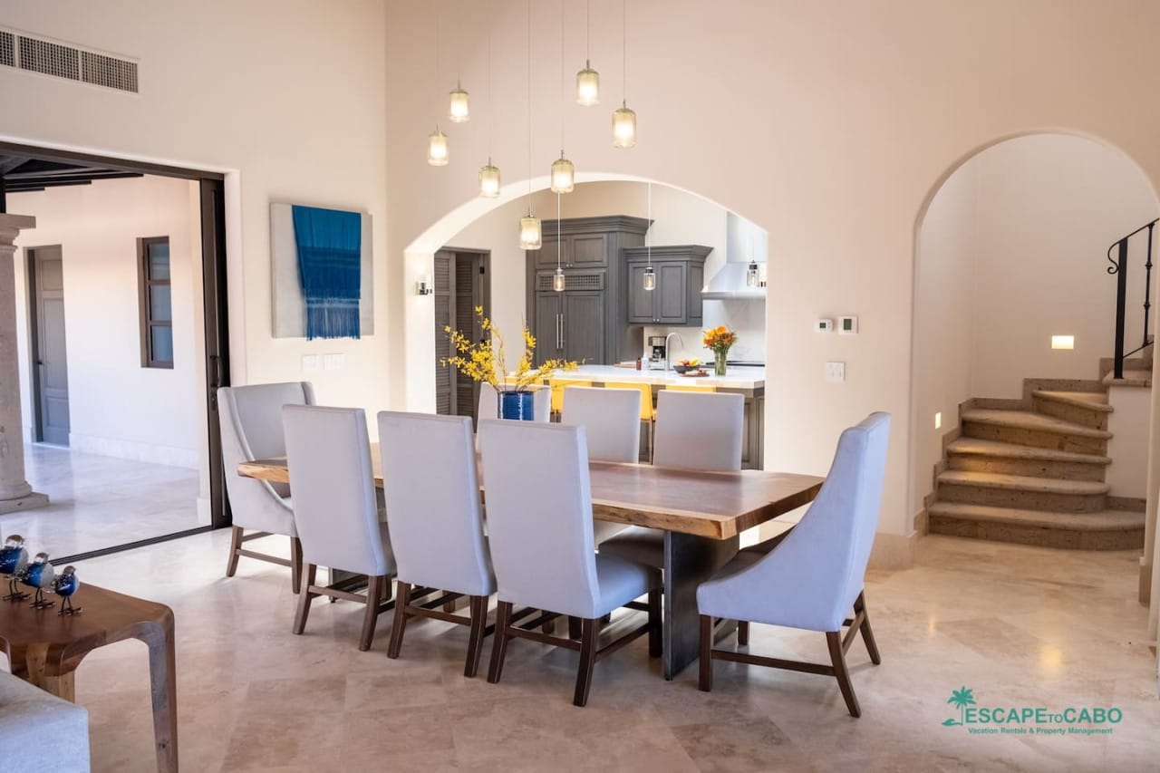 Modern dining room with staircase.