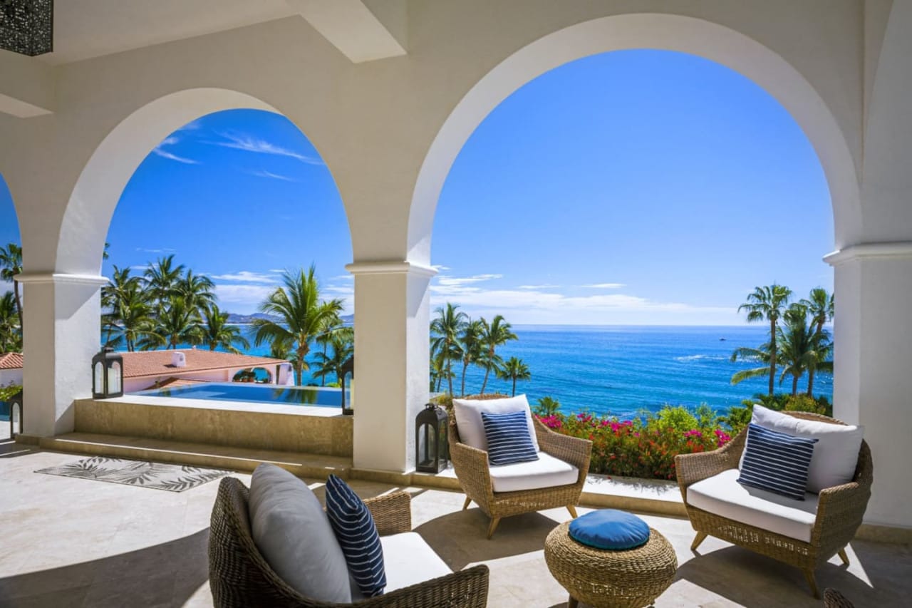 Ocean view balcony with seating.