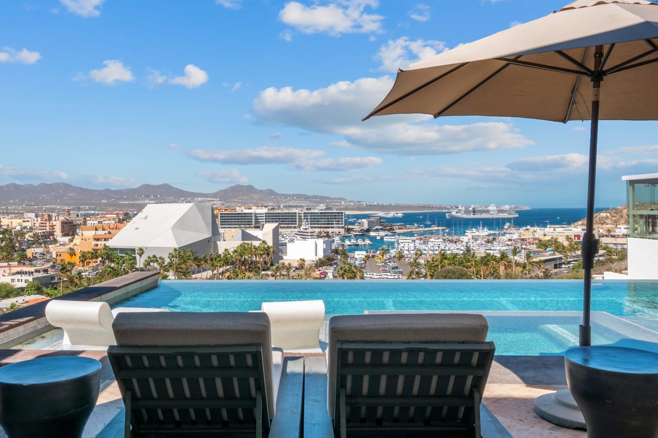 Poolside chairs overlooking marina view.