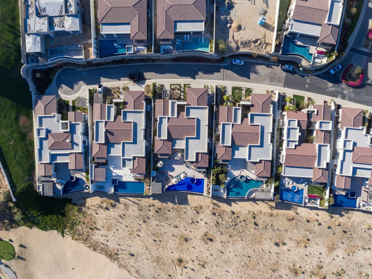 Aerial view of houses with pools.