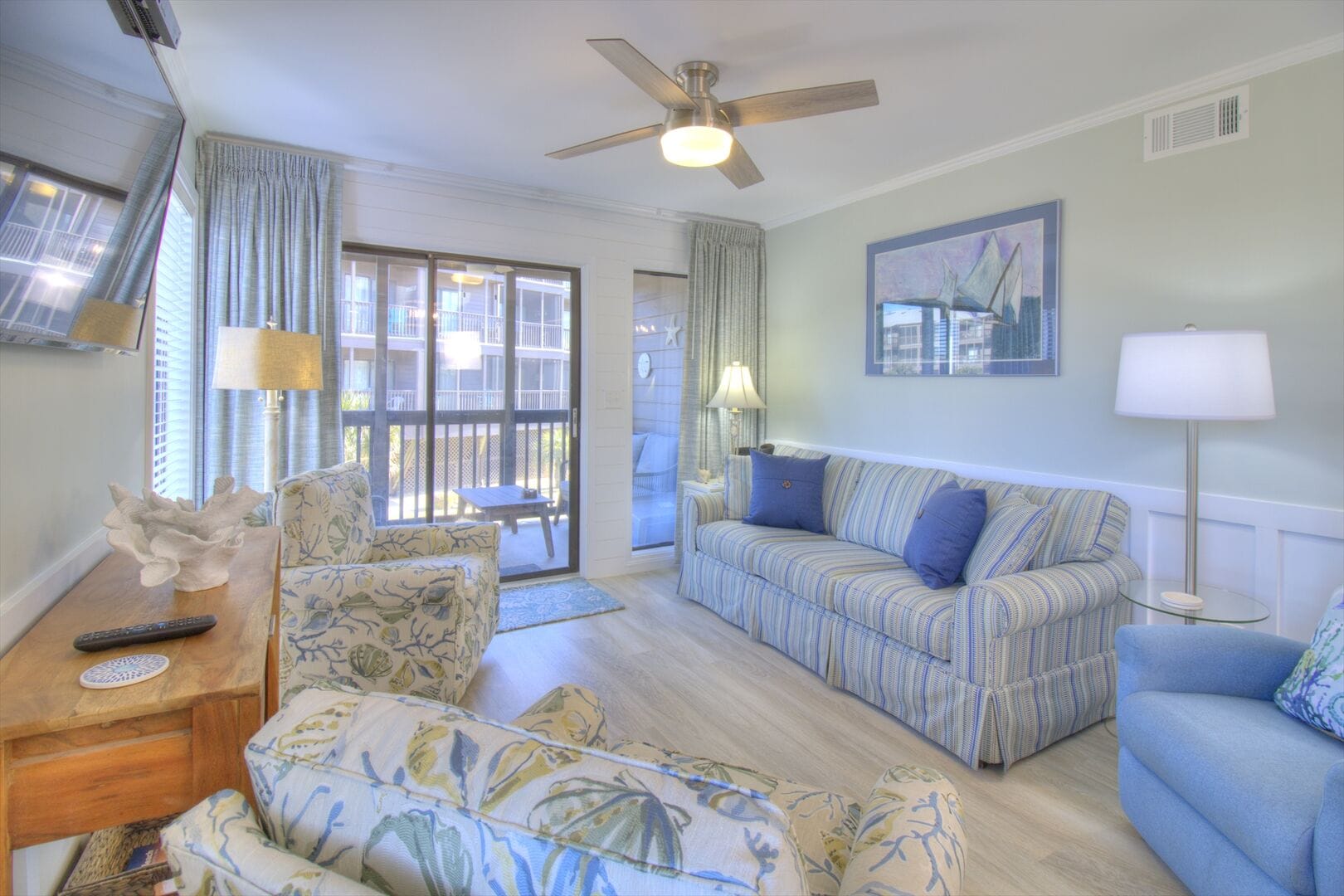 Coastal-themed living room with balcony.