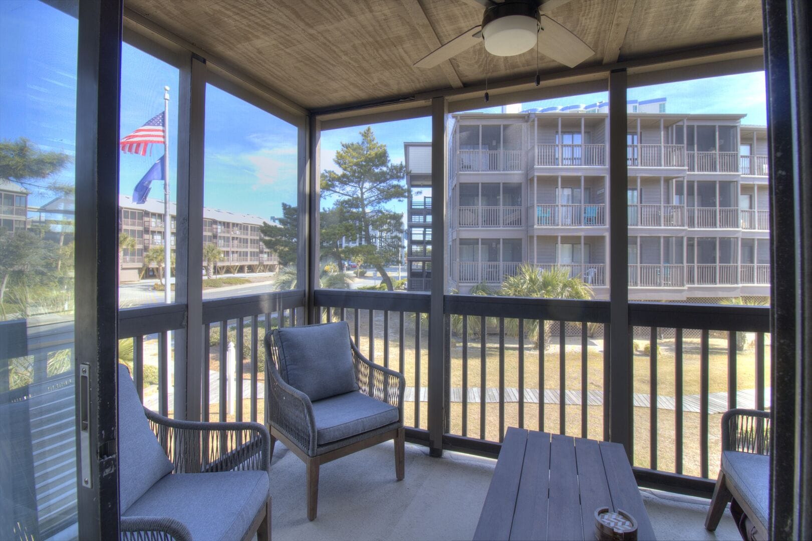 Screened porch with outdoor furniture.