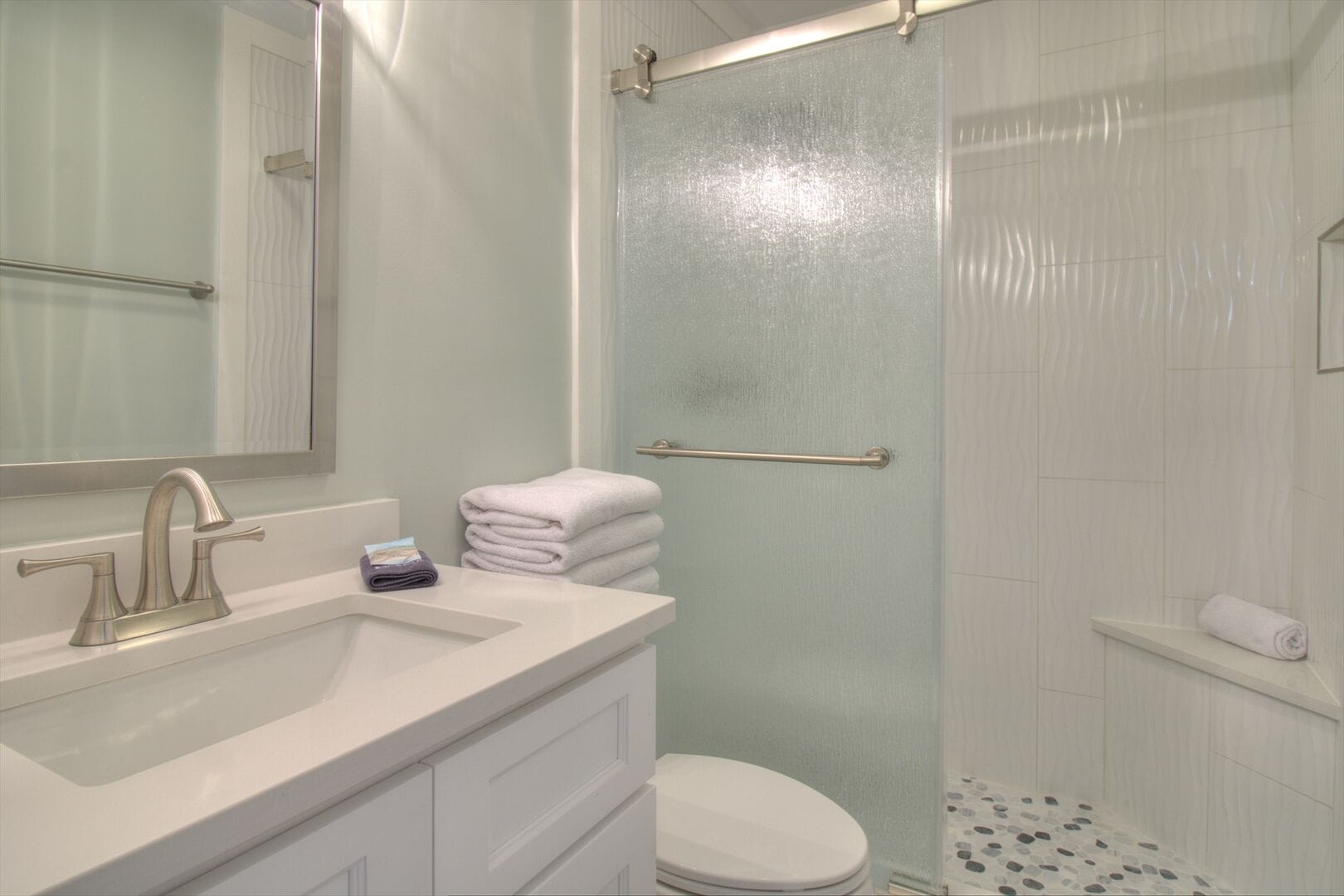 Modern bathroom with shower and sink.