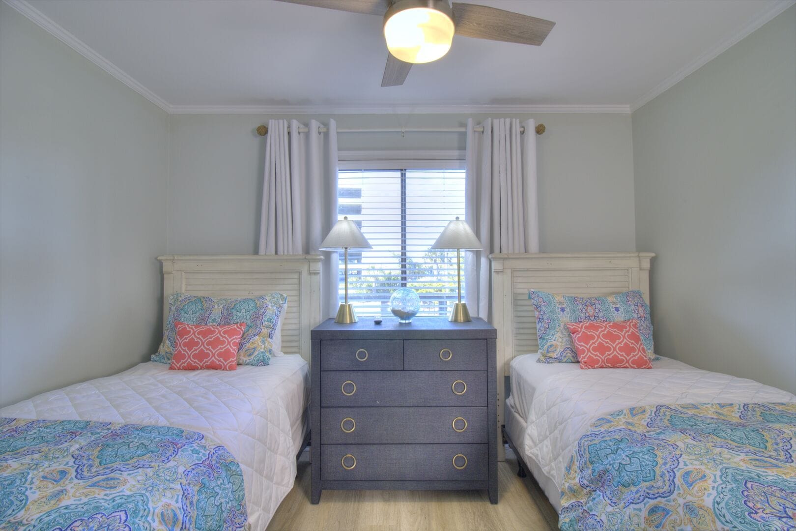 Bedroom with twin beds, dresser.