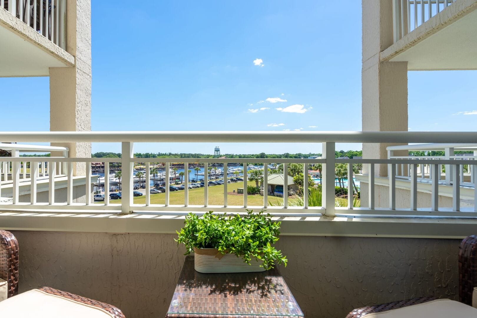 Balcony view overlooking marina and greenery.