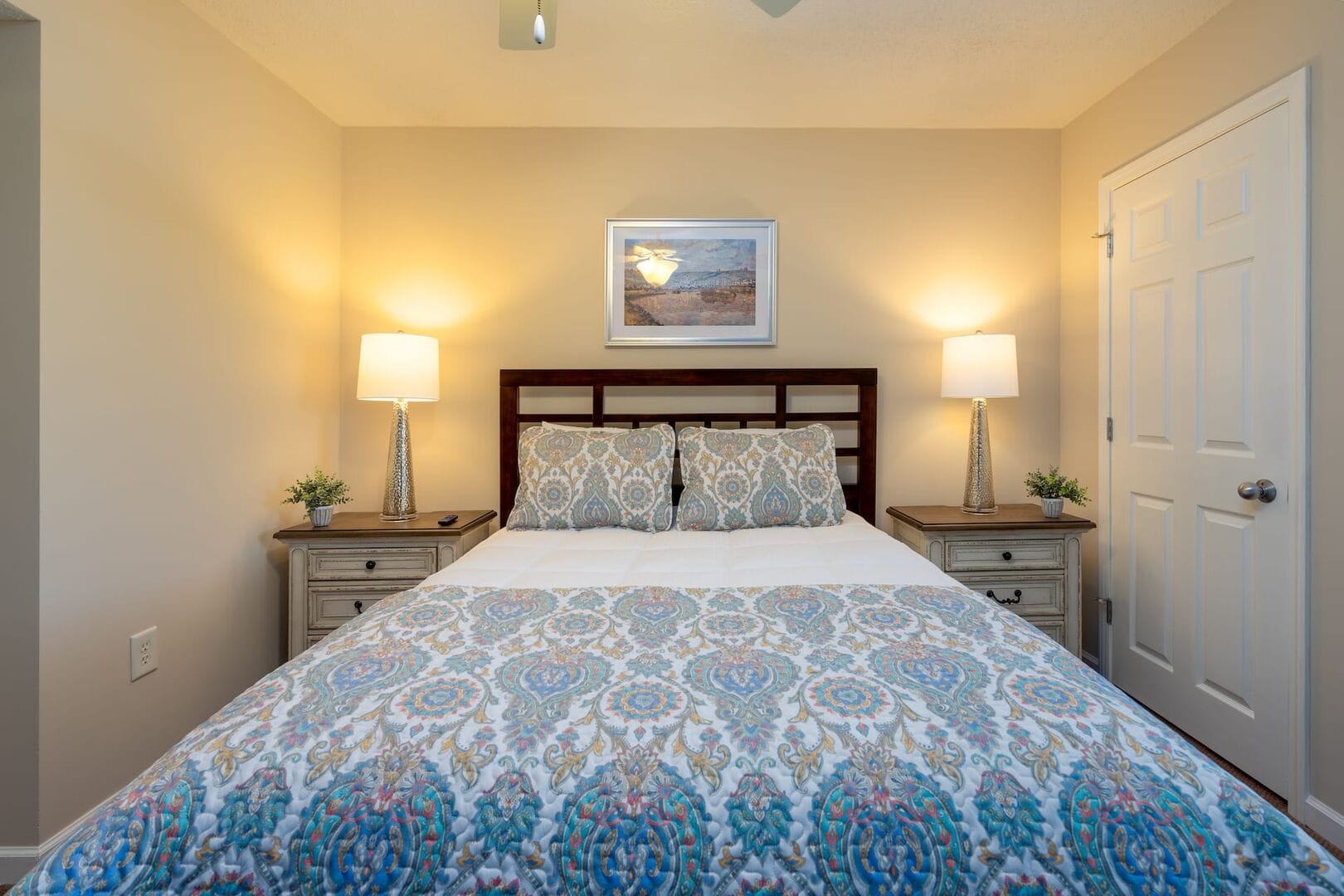 Cozy bedroom with patterned bedding.