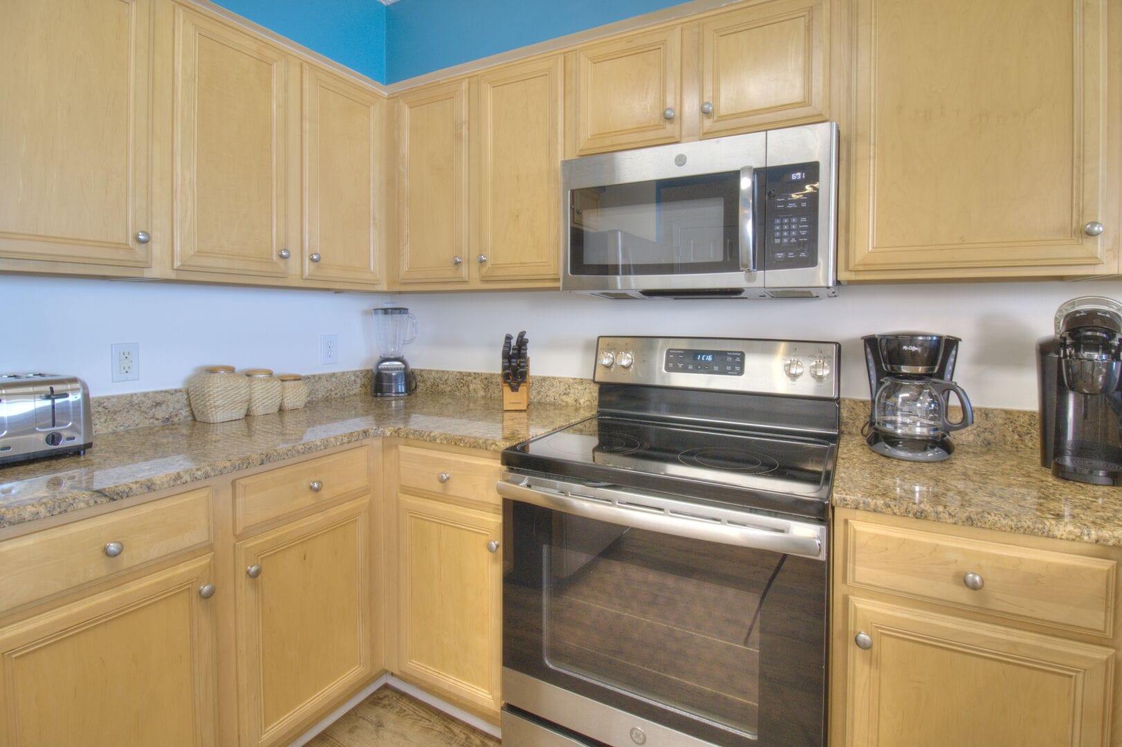 Modern kitchen with appliances, cabinets.