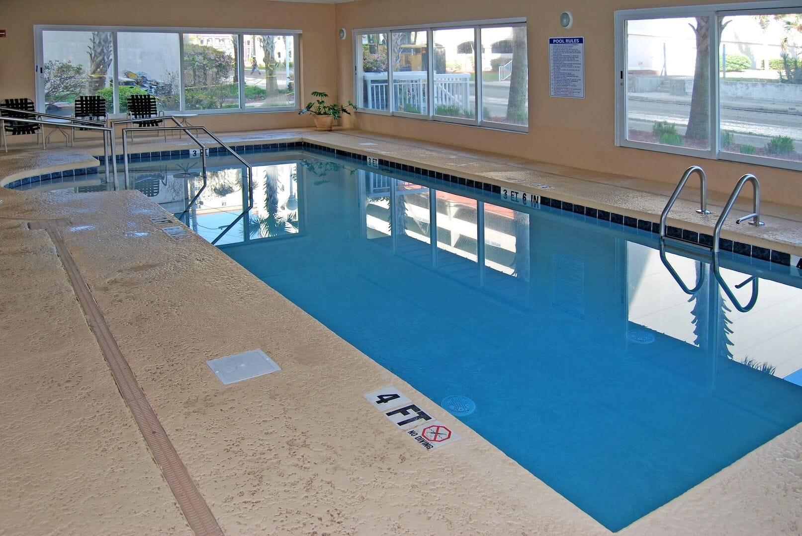 Indoor pool with seating area.