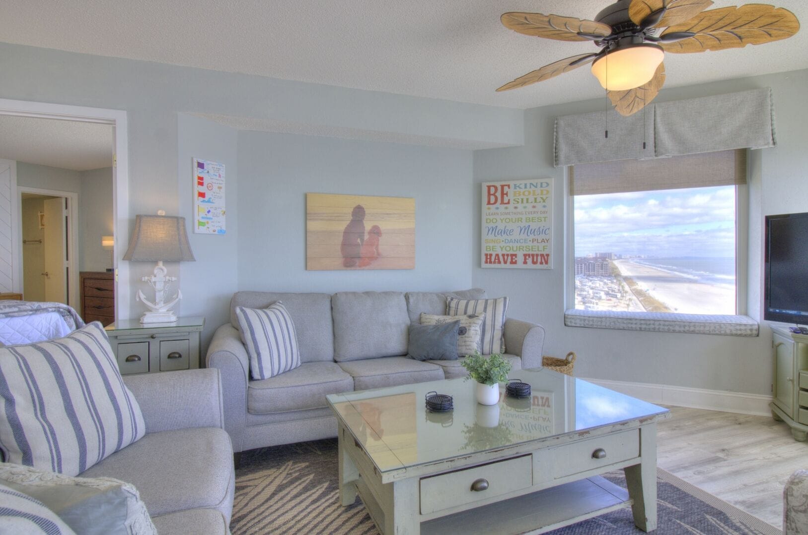 Coastal-themed living room with view.