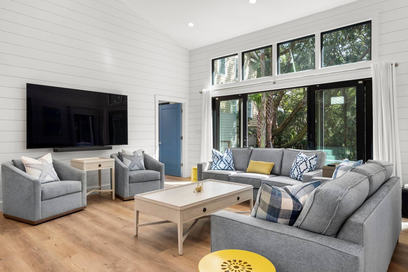 Modern living room with large windows.