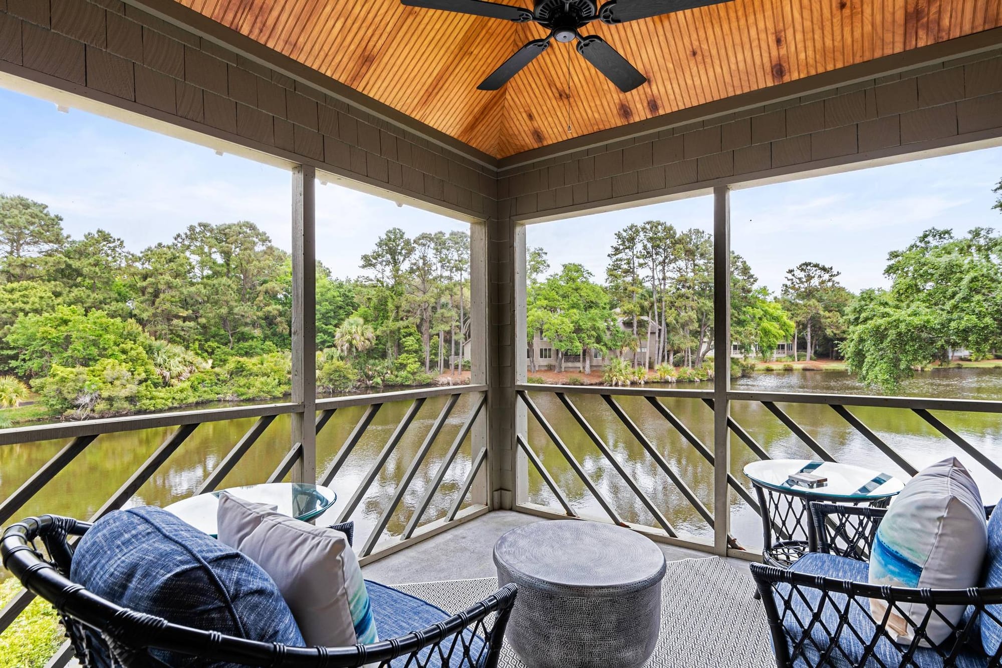 Screened porch overlooking scenic lake.