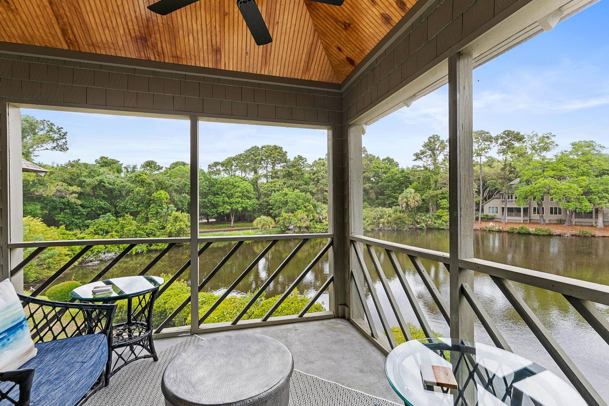 Screened porch overlooking peaceful lake.