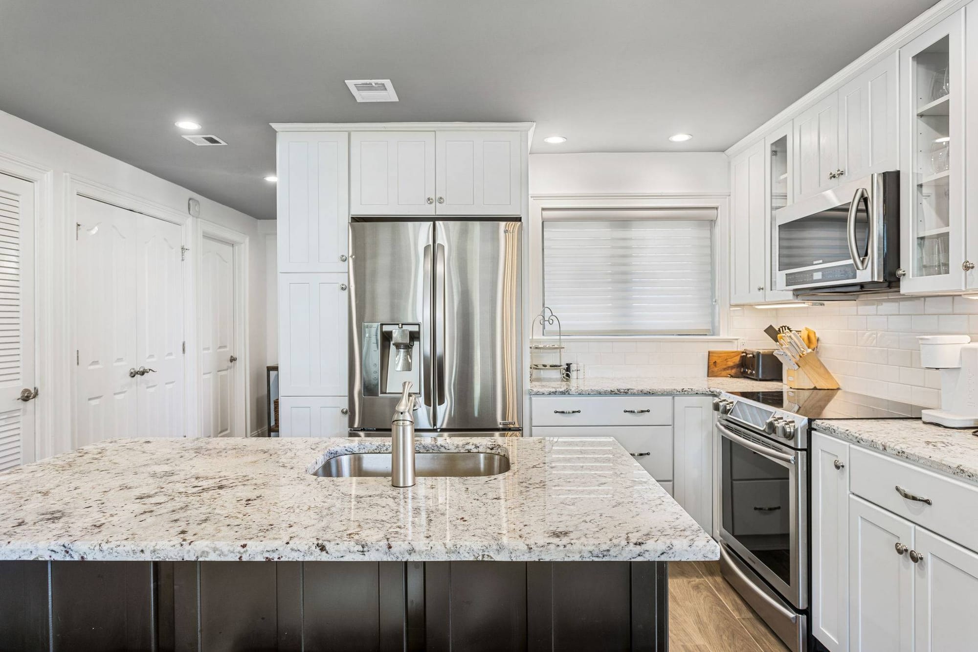 Modern kitchen with granite countertops.