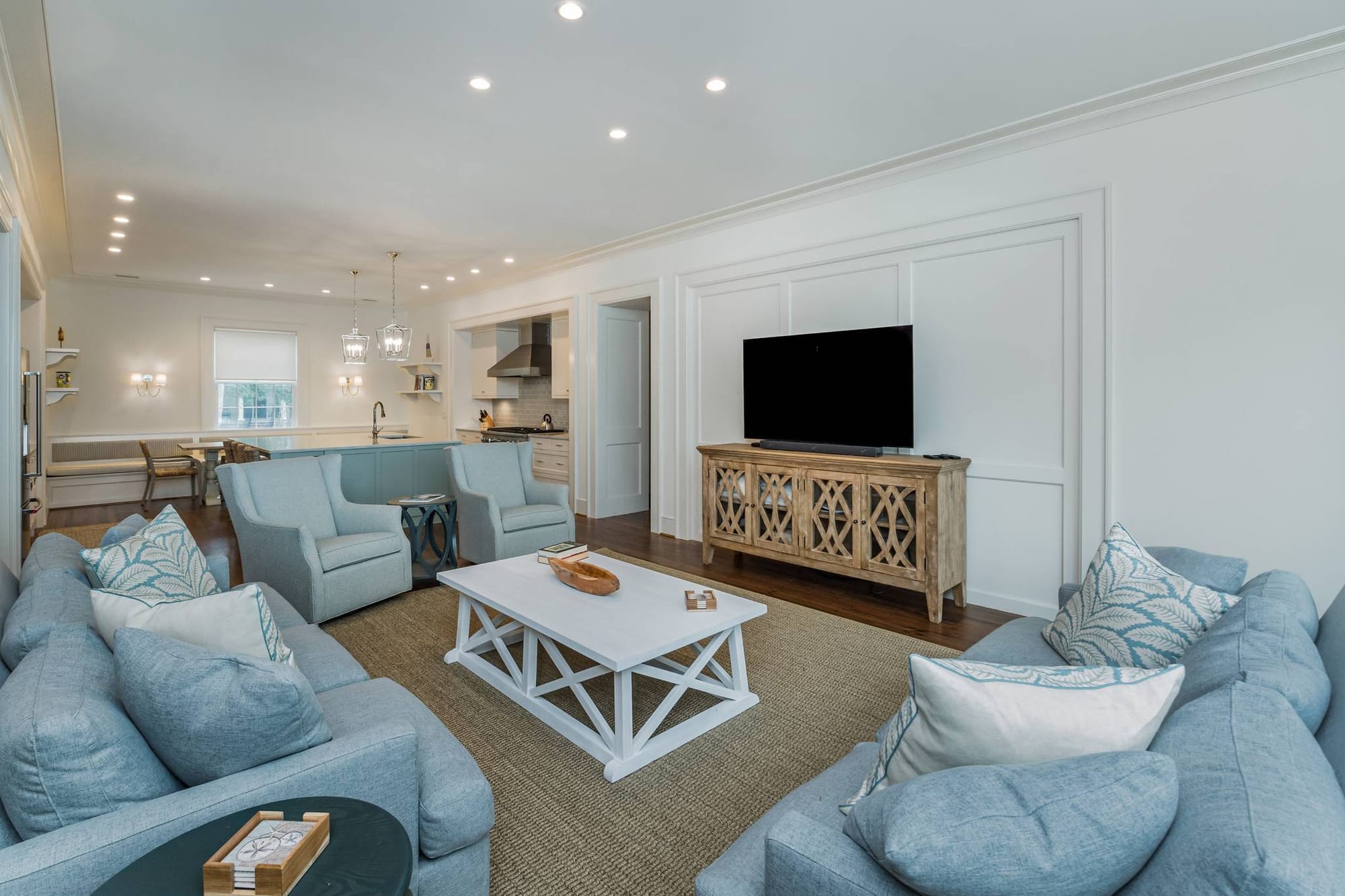 Spacious living room with blue sofas.