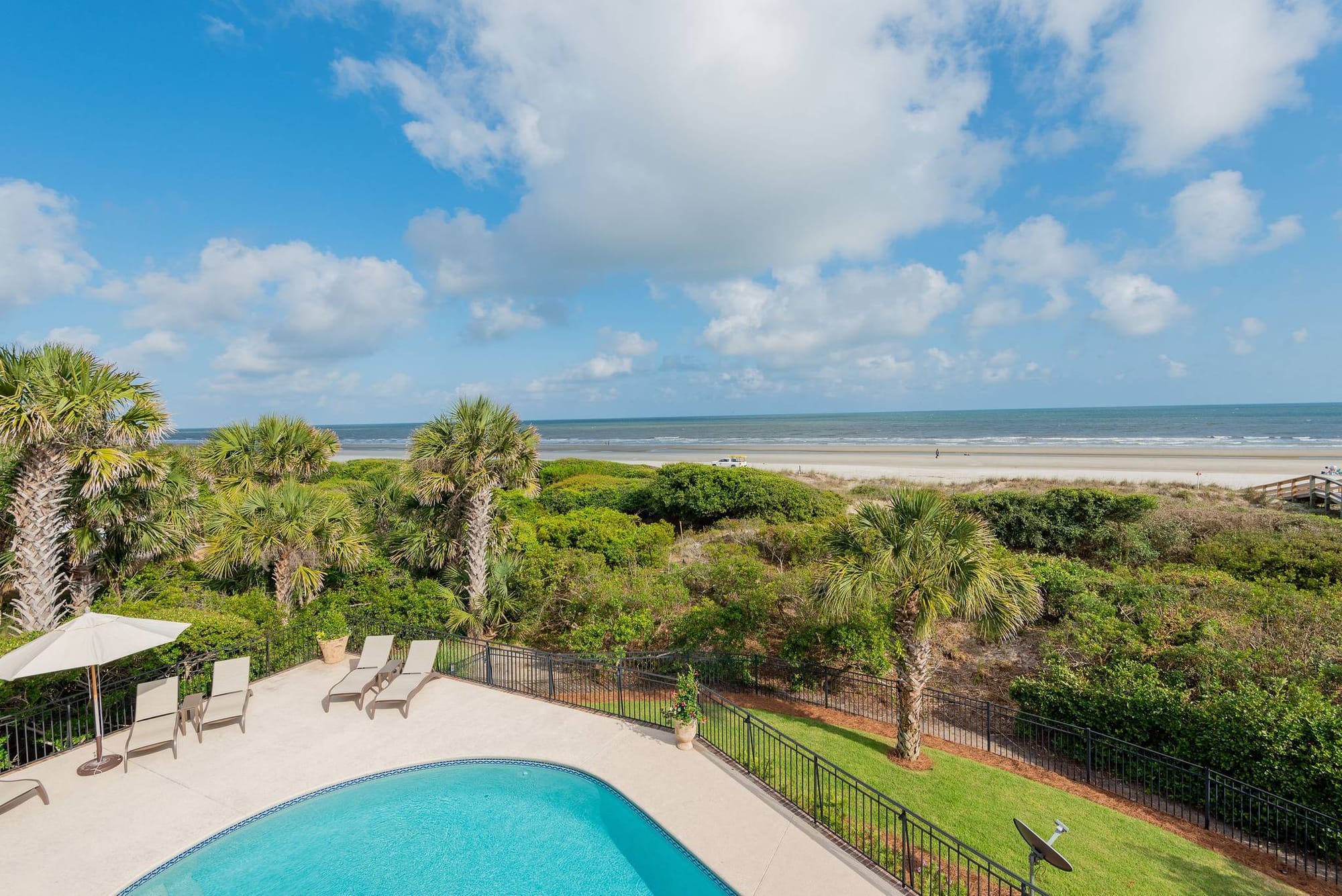 Coastal view with pool and beach.