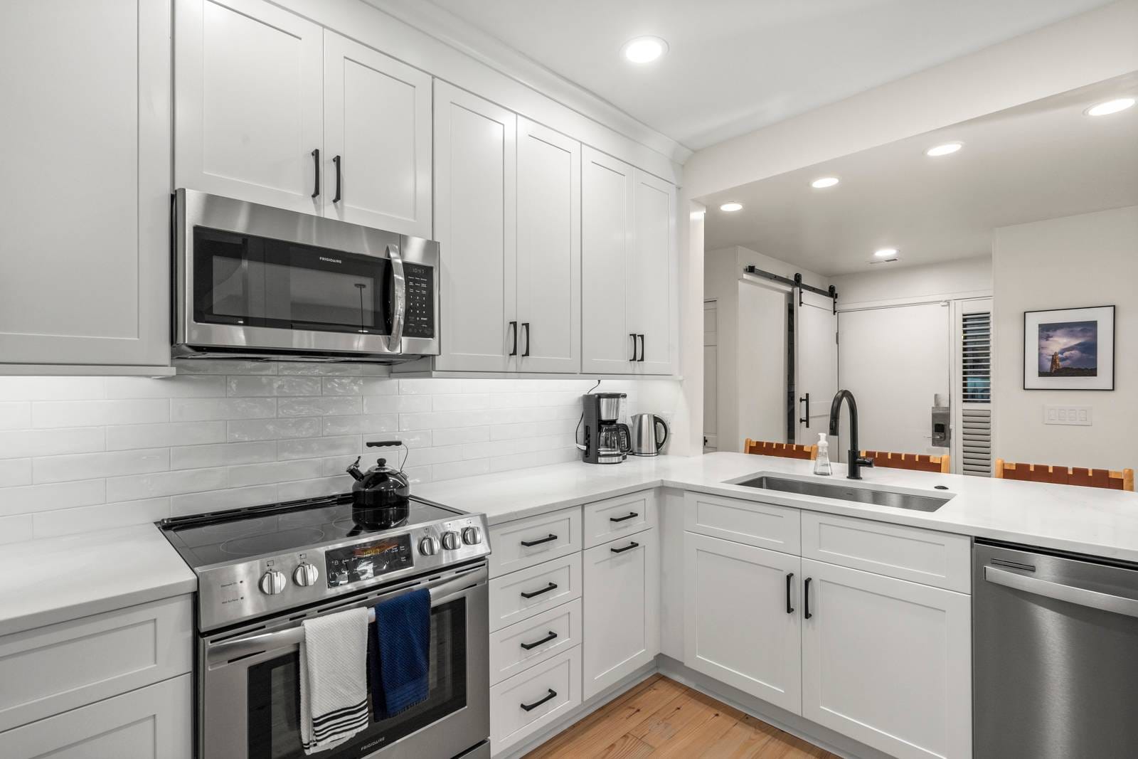 Modern white kitchen with appliances.