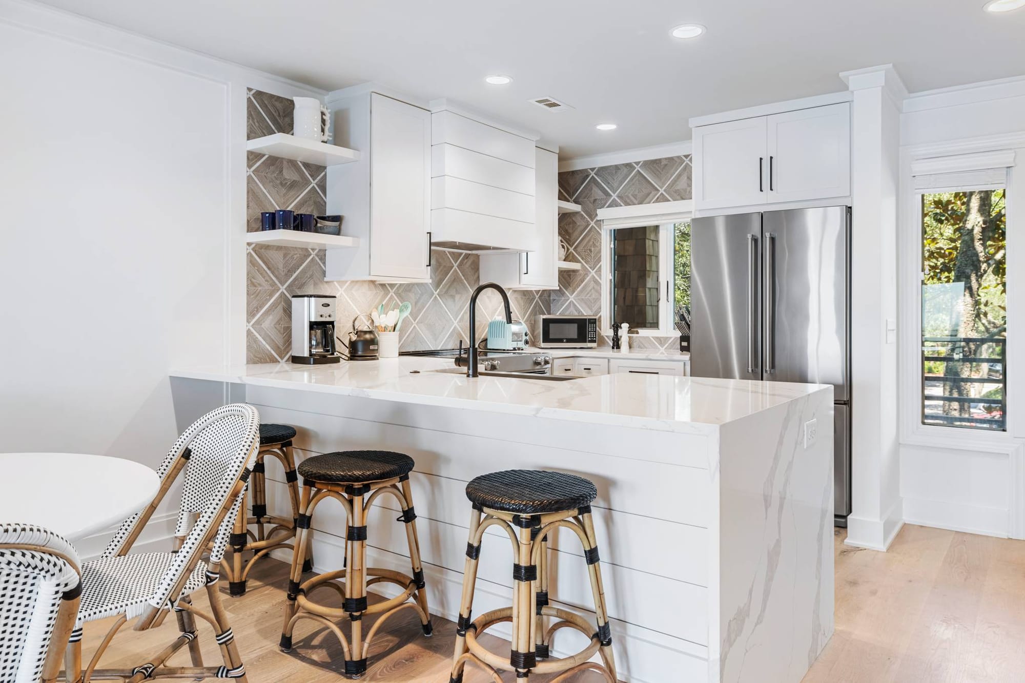 Modern kitchen with island and stools.