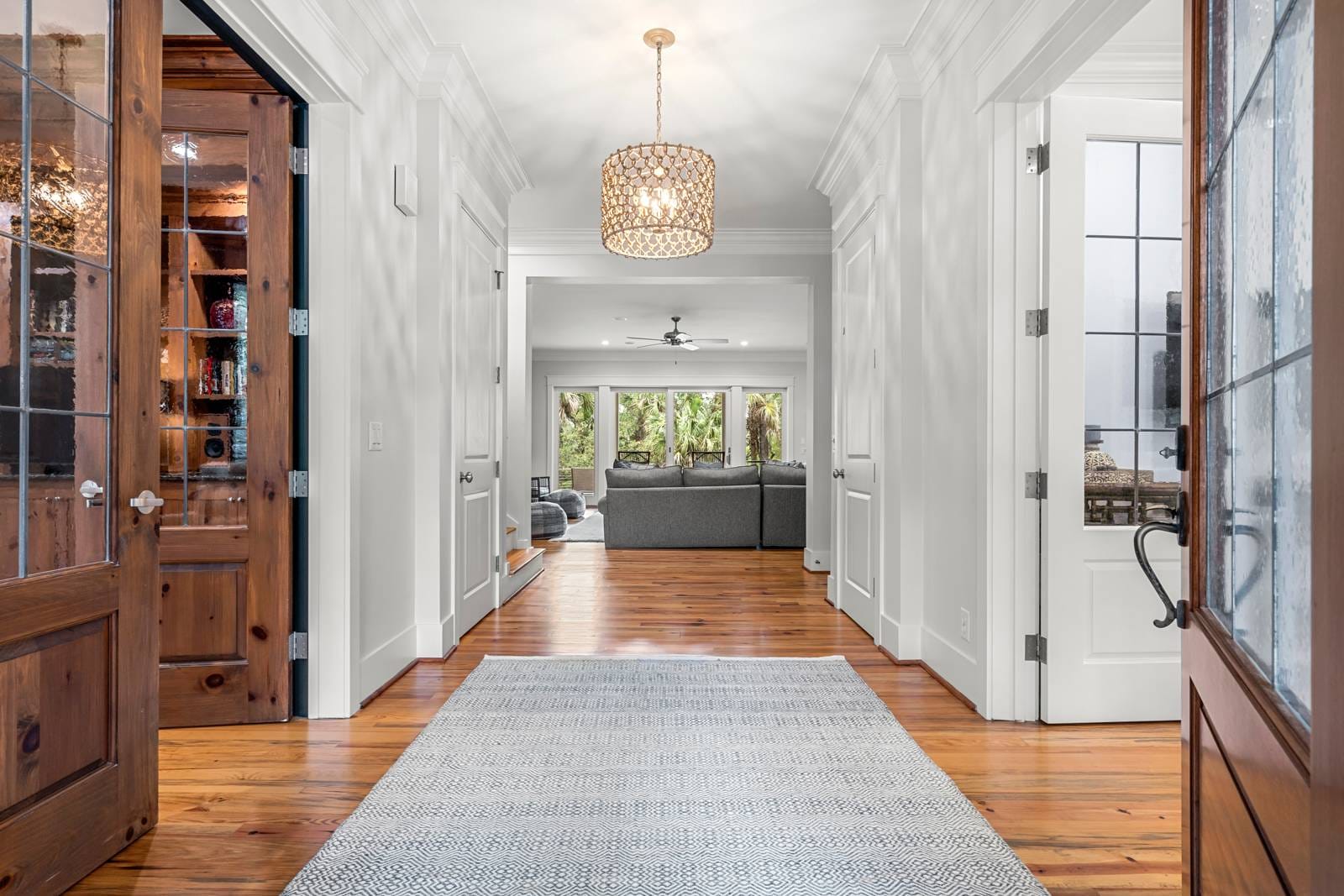 Elegant hallway with chandelier lighting.