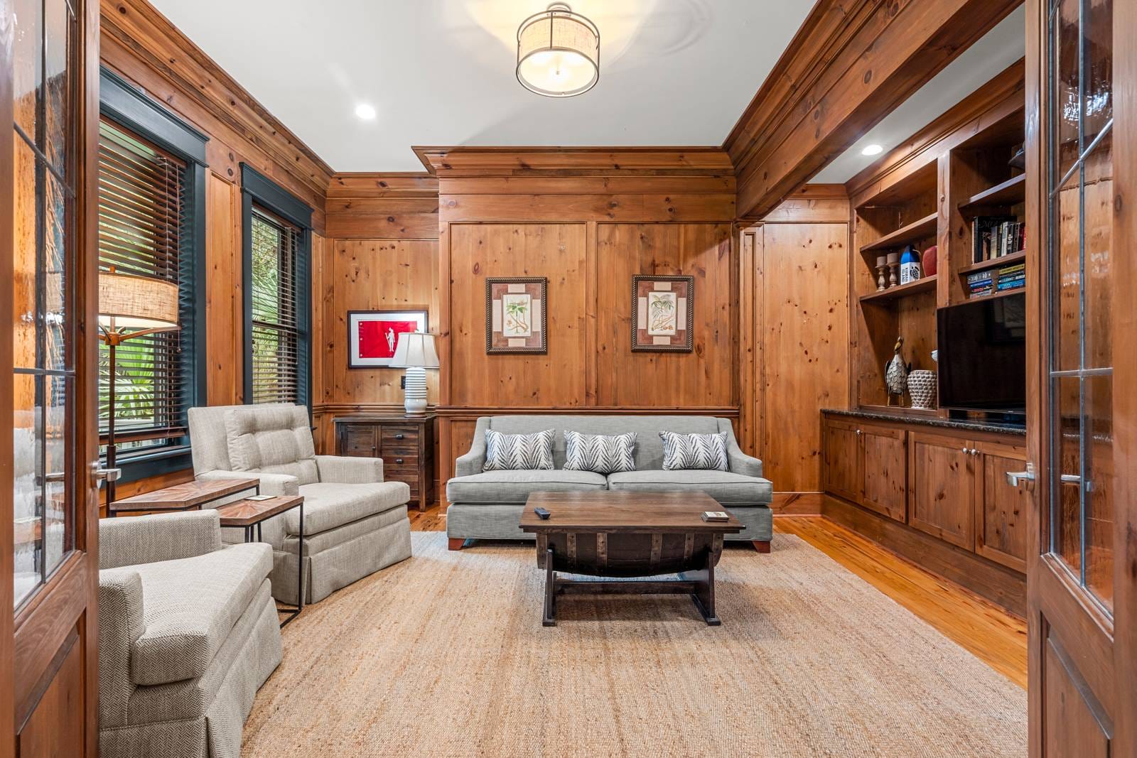 Wood-paneled living room with furniture.