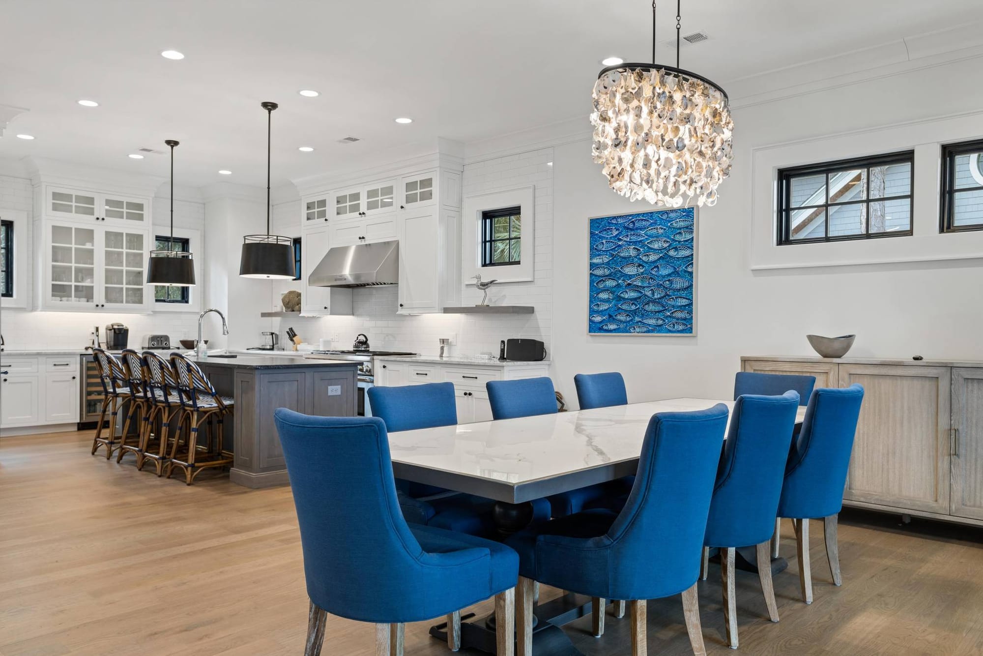 Modern kitchen with blue chairs.