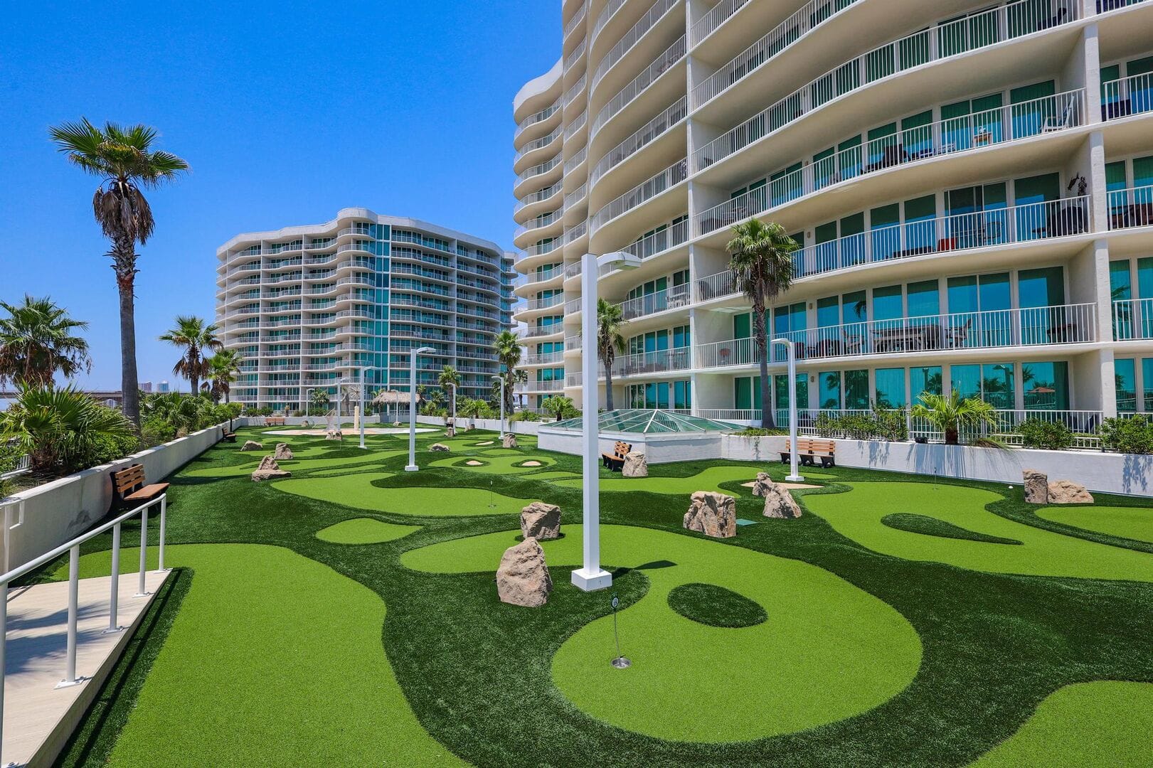 Mini-golf course by modern building.