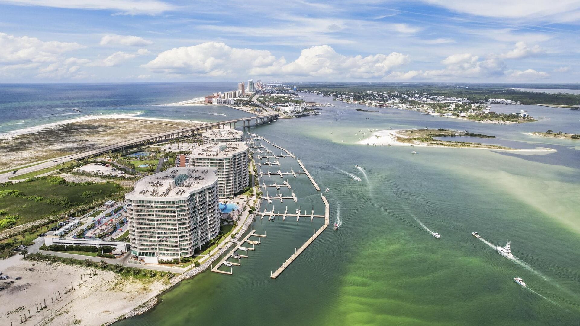 Coastal cityscape with waterfront buildings.