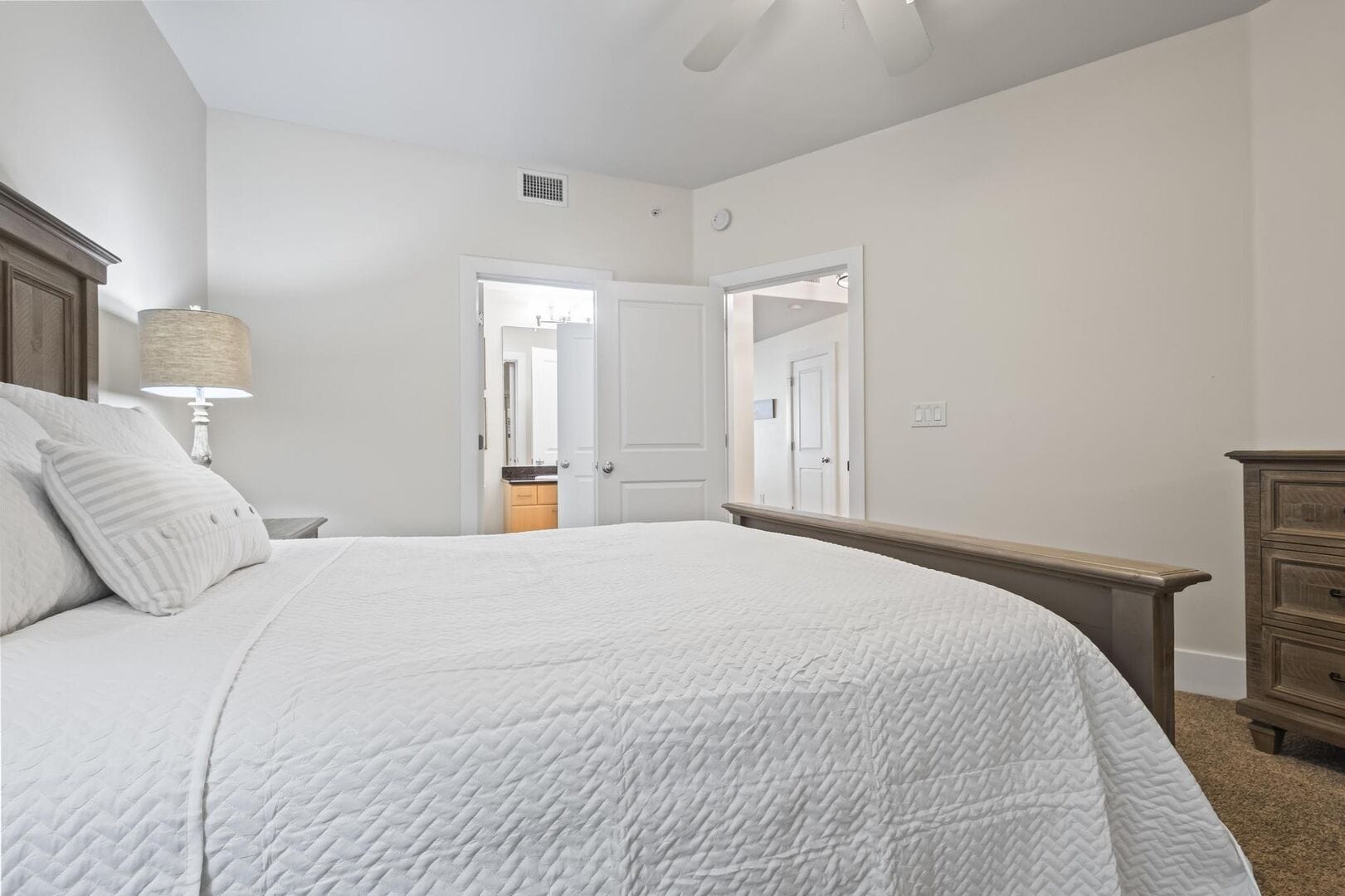 Bedroom with bed and dresser.