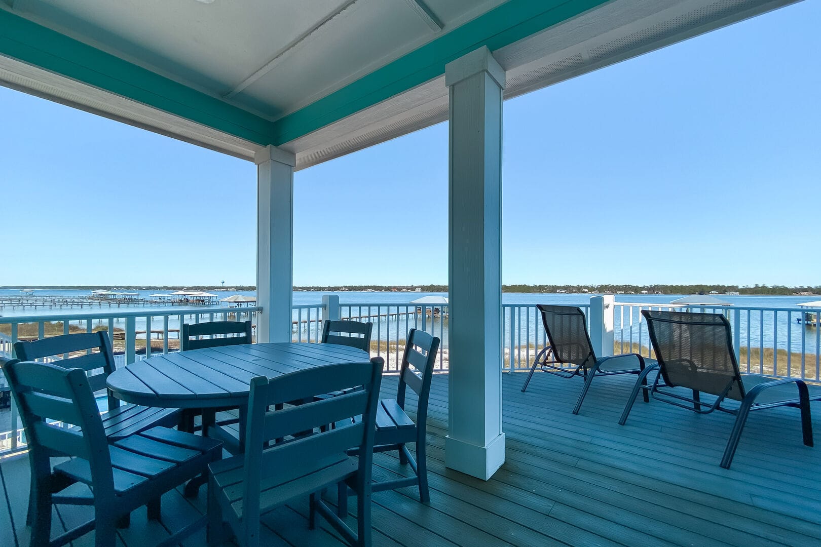 Deck overlooking water with seating.