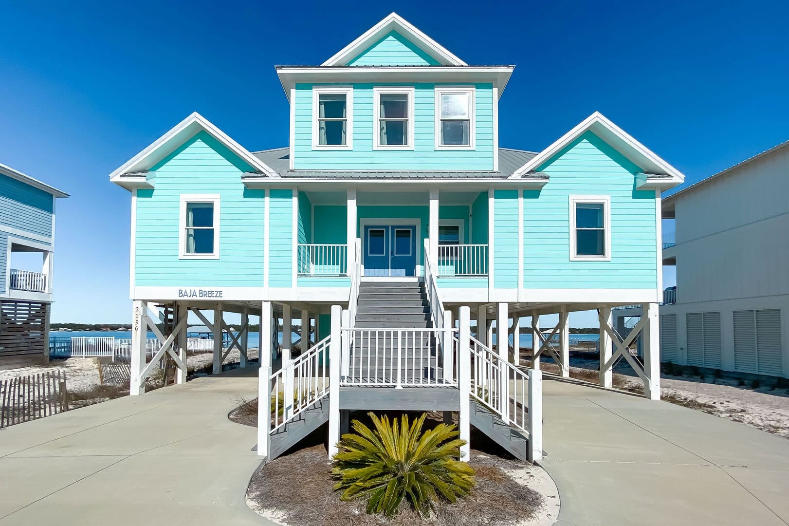 Blue stilt house with stairs.