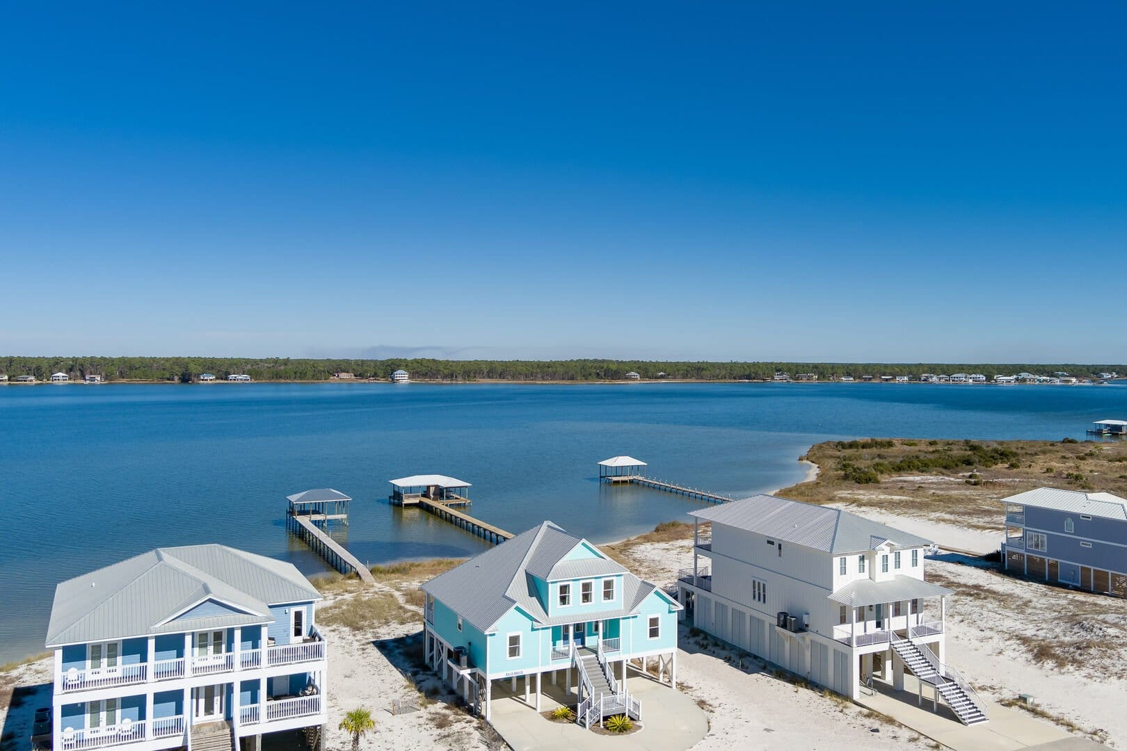 Waterfront houses with piers, lake.