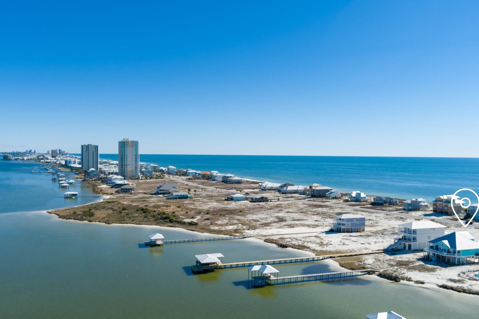 Coastal skyline with buildings and ocean.