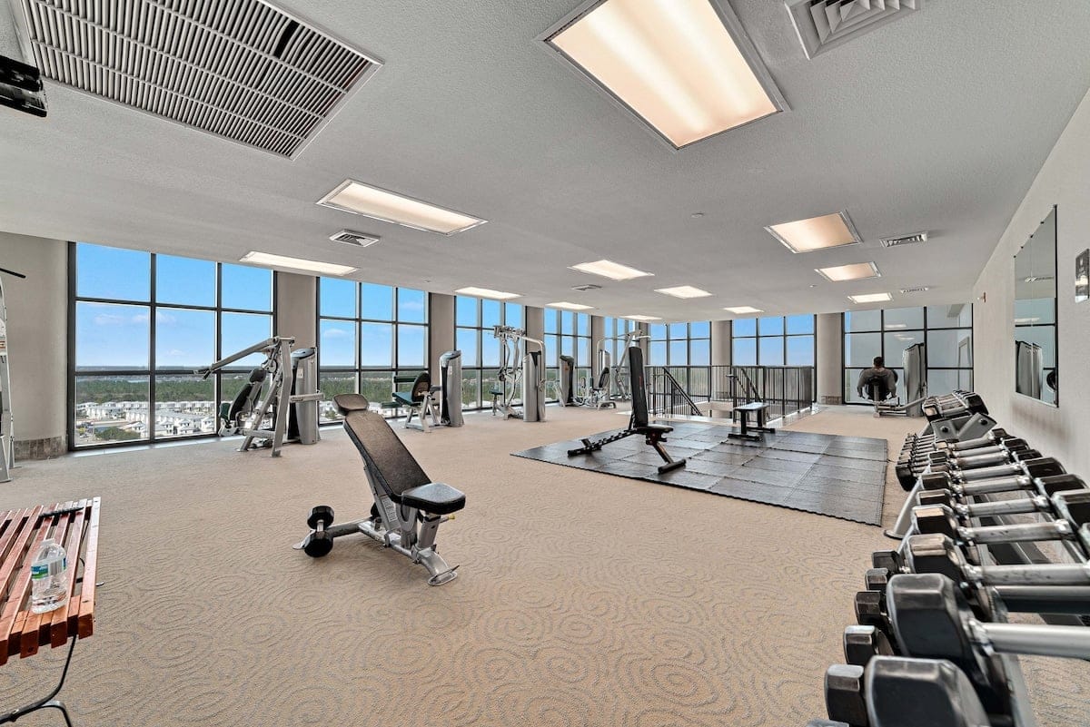 Spacious gym with exercise equipment.