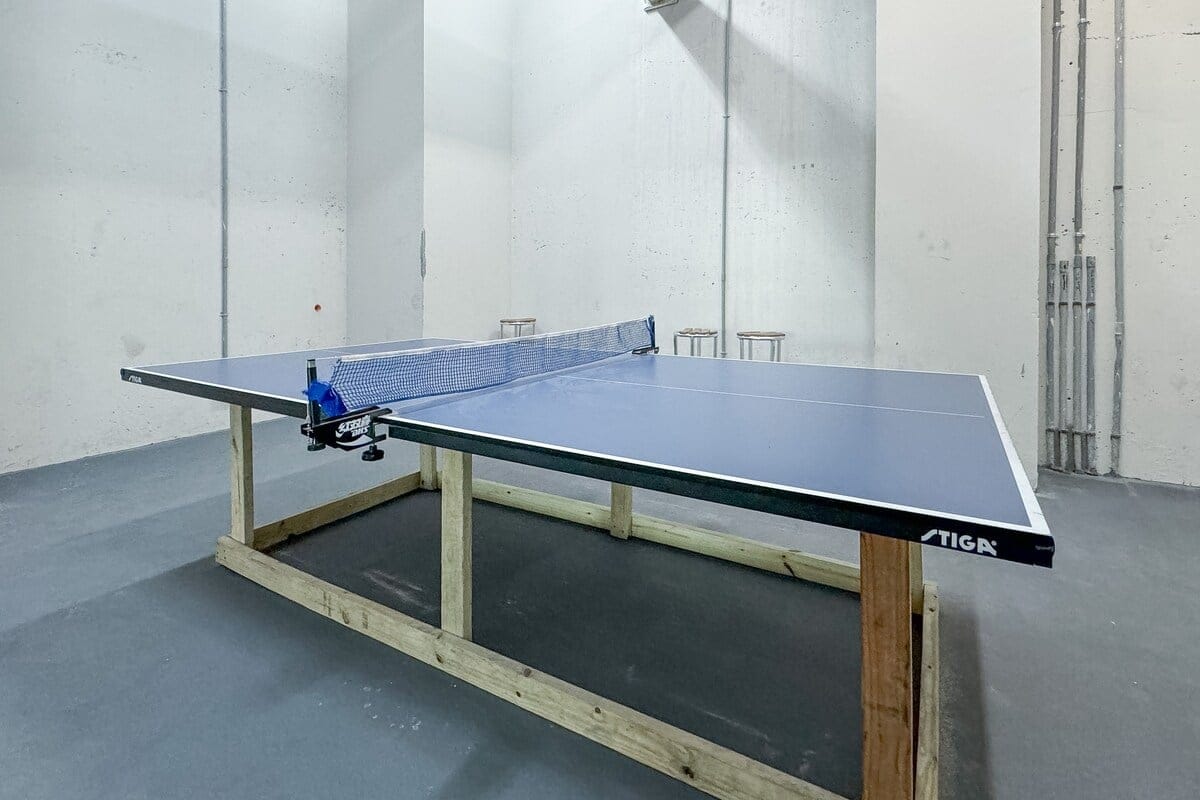 Makeshift table tennis setup indoors.