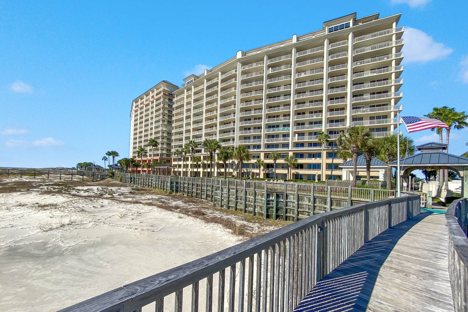 Beachfront condominium building and boardwalk.