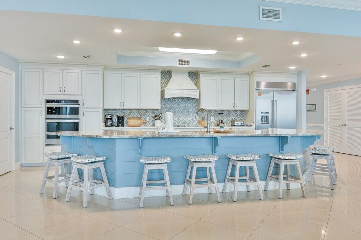 Spacious kitchen with blue island.