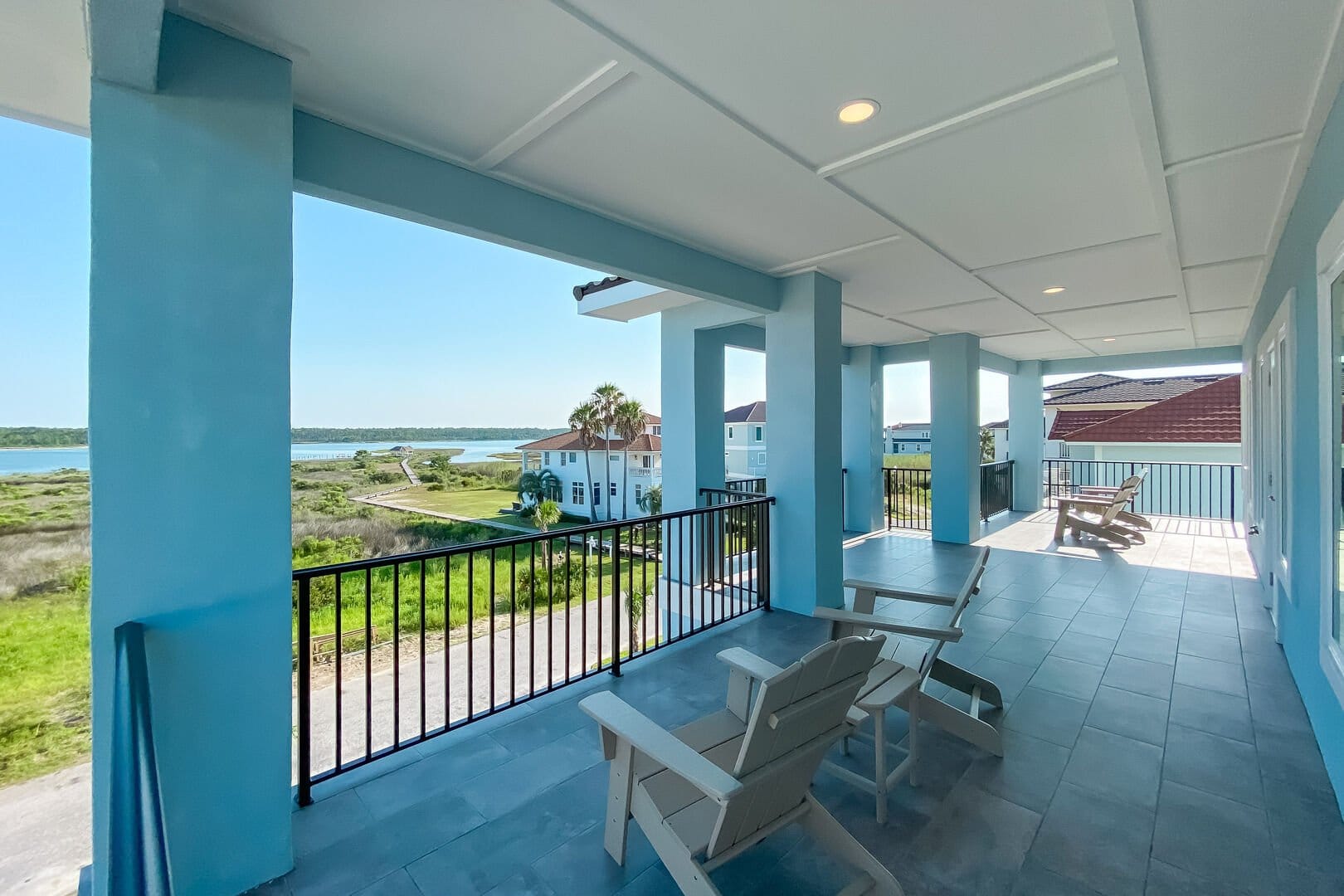 Blue balcony overlooking waterfront scenery.